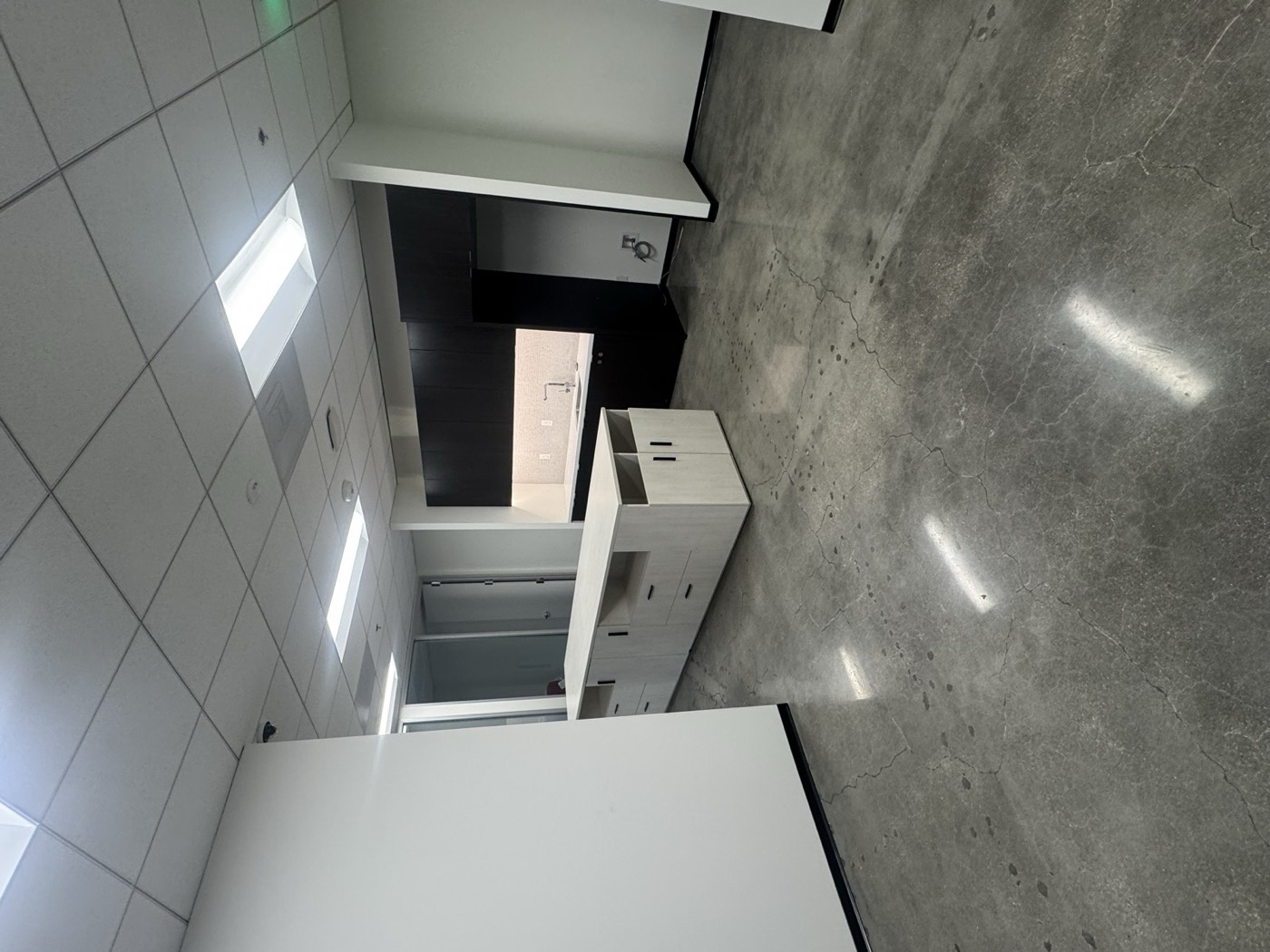 Finished breakroom with custom millwork island and polished concrete flooring, AGA corporate office tenant improvement